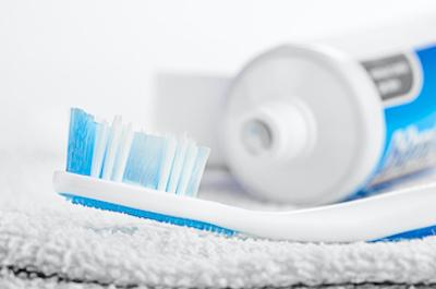 Toothbrush laying next to toothpaste, tuscaloosa al