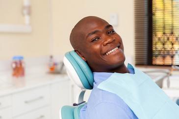 Black man smiling sitting in dental chair, tuscaloosa al
