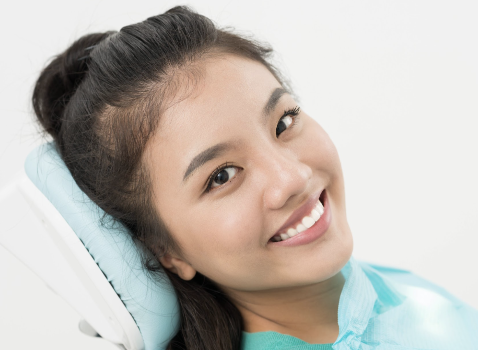 Asian woman smiling in dental chair, tuscaloosa al