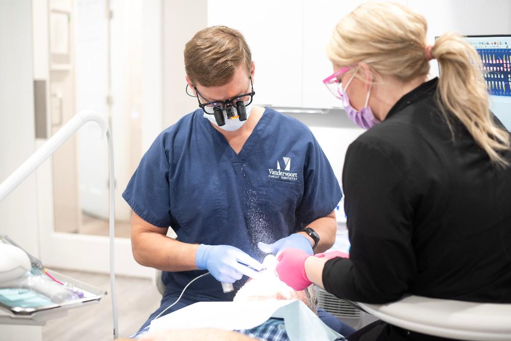 dentist at vandervoort family dentistry helping a patient