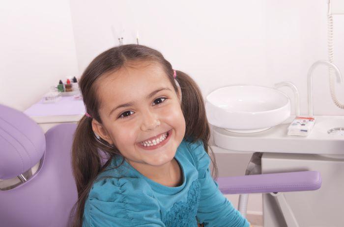 Young girl smiling in dentist chair, tuscaloosa al