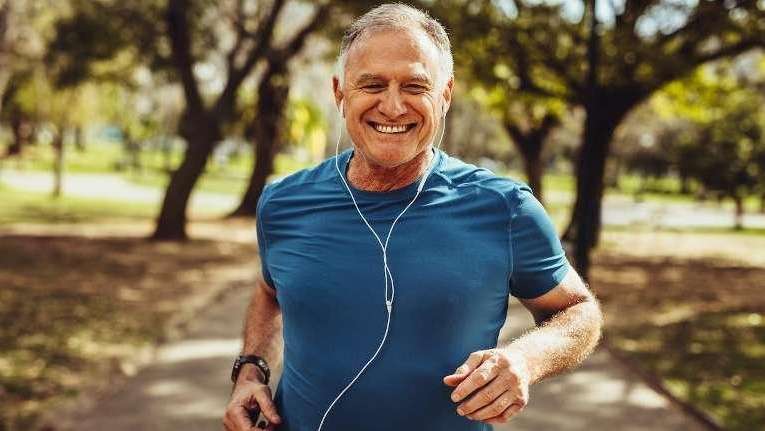 Older man running with headphones in, tuscaloosa al