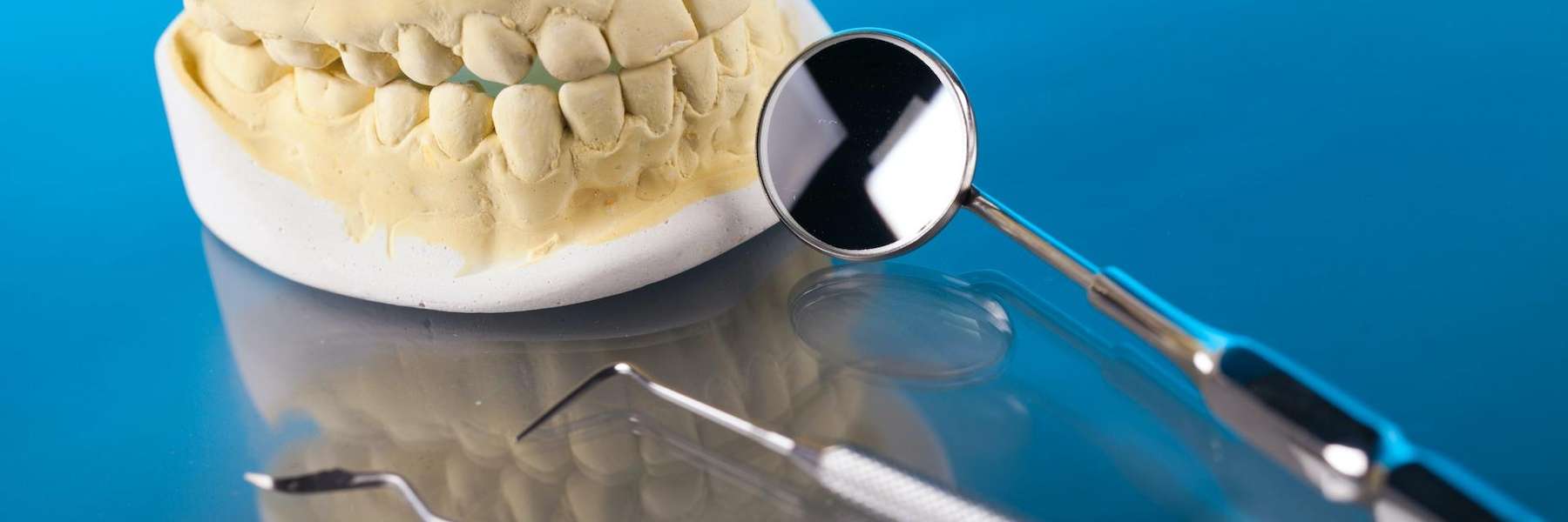 Dentist tools next to a clay mold of a mouth, tuscaloosa al