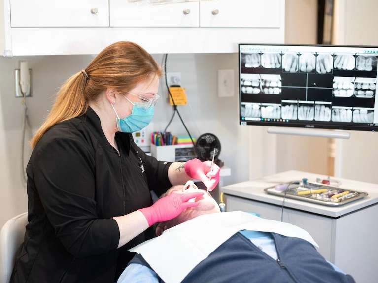 hygienist looking at patient's digital x-rays, tuscaloosa al